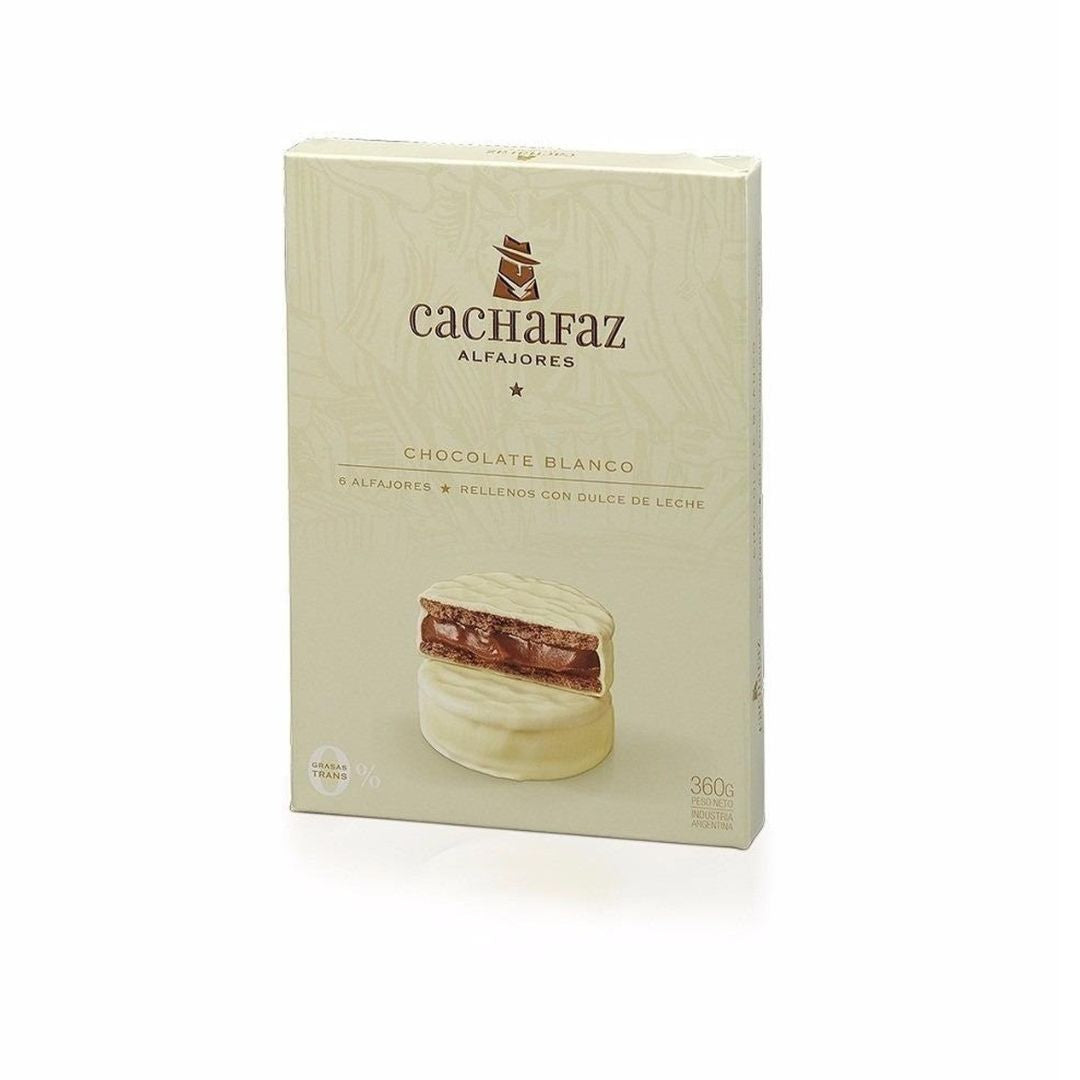 Cachafaz White Chocolate Alfajor with thick dulce de leche filling on a wooden plate